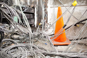 infrastructure wires with orange safety cone