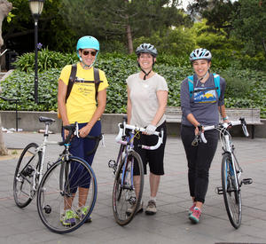 group of 3 employees pose on bike to work day